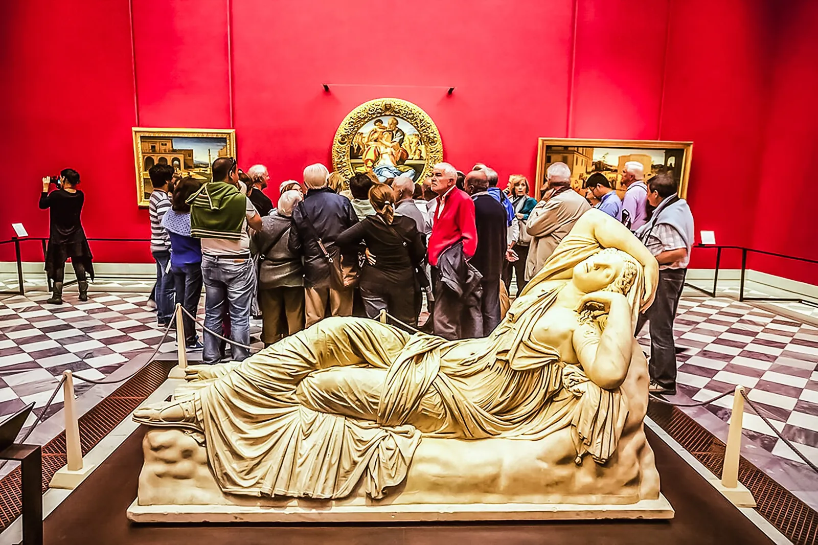 A reclining marble figure in one of the Uffizi's red rooms
