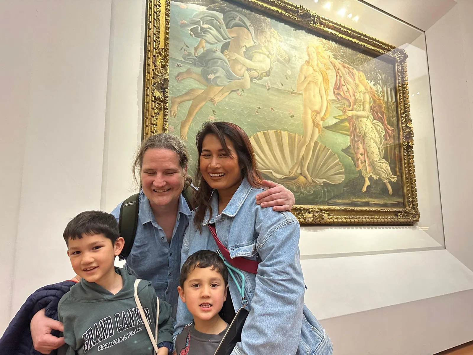 A family with two boys in front of Botticelli's Birth of Venus