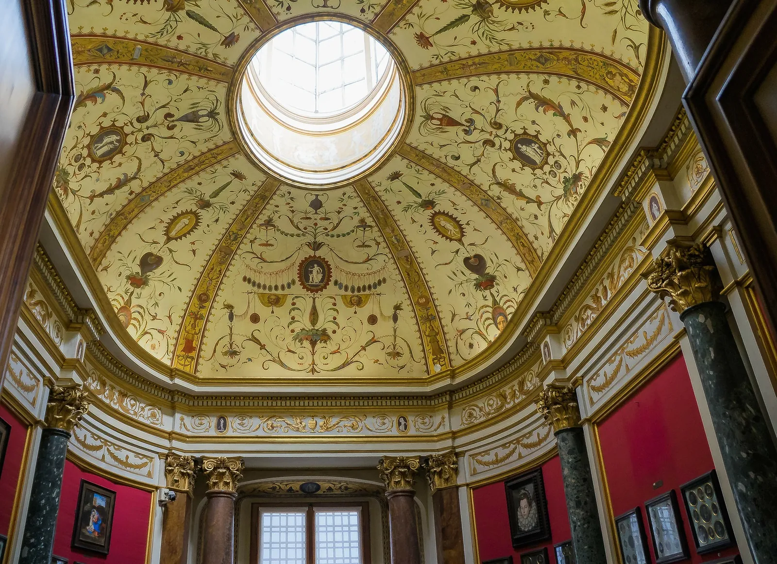 A domed, frescoed ceiling in one of the Uffizi's historic rooms