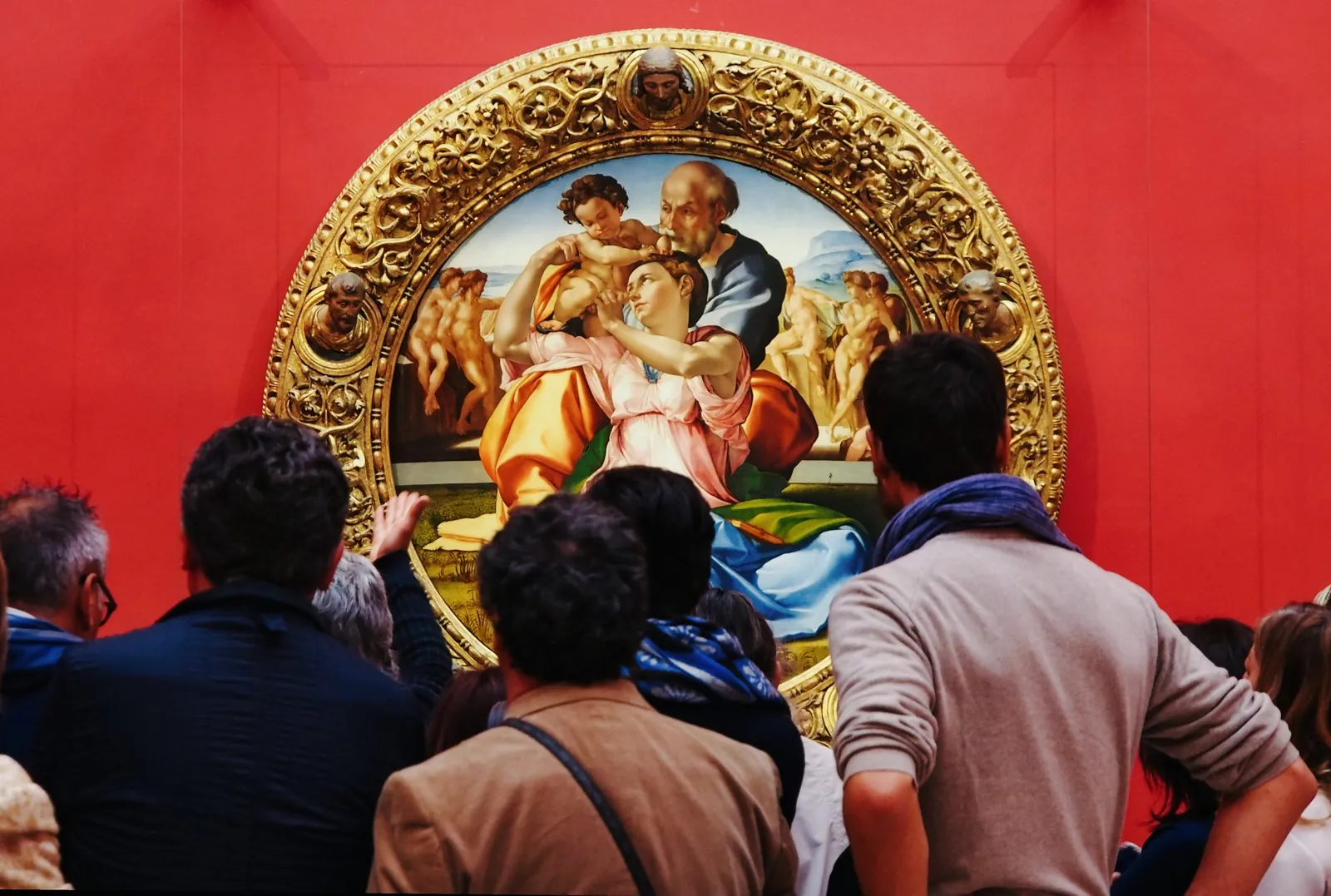 Visitors crowding around Michelangelo's Doni Tondo