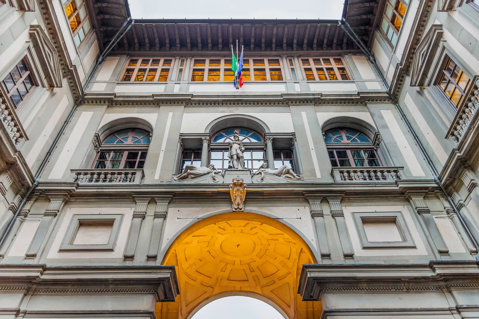 Looking up at the Uffizi's courtyard façade above the river arch