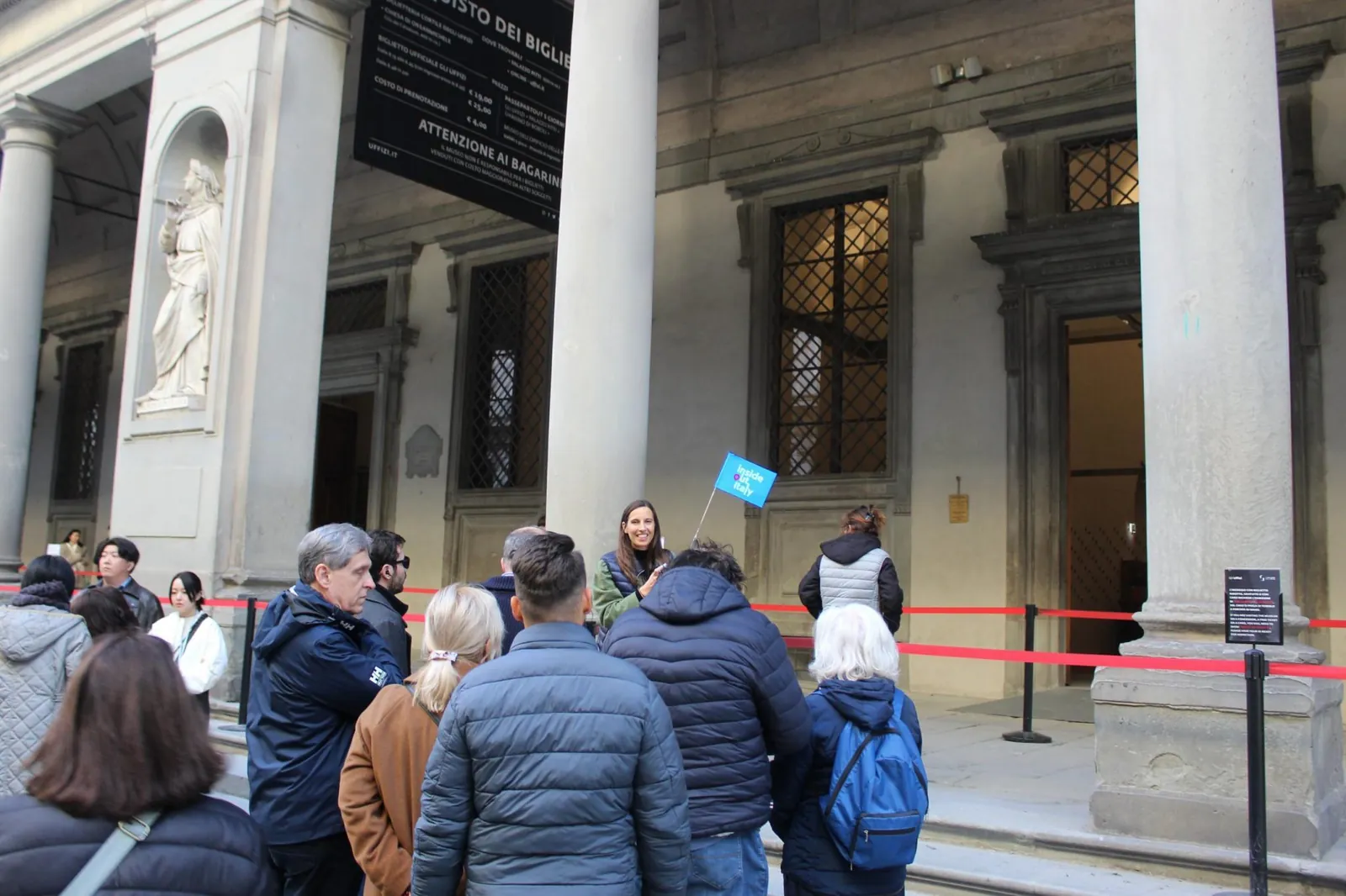 Small group meeting their guide under the Uffizi loggia before reserved entry