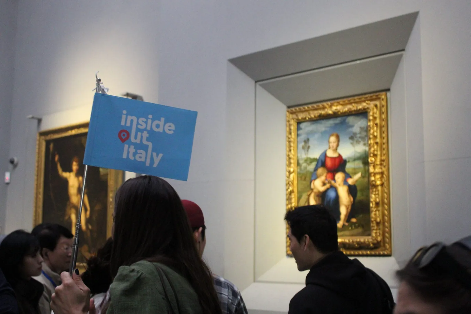 Tour group with their guide in front of Raphael's Madonna of the Goldfinch at the Uffizi