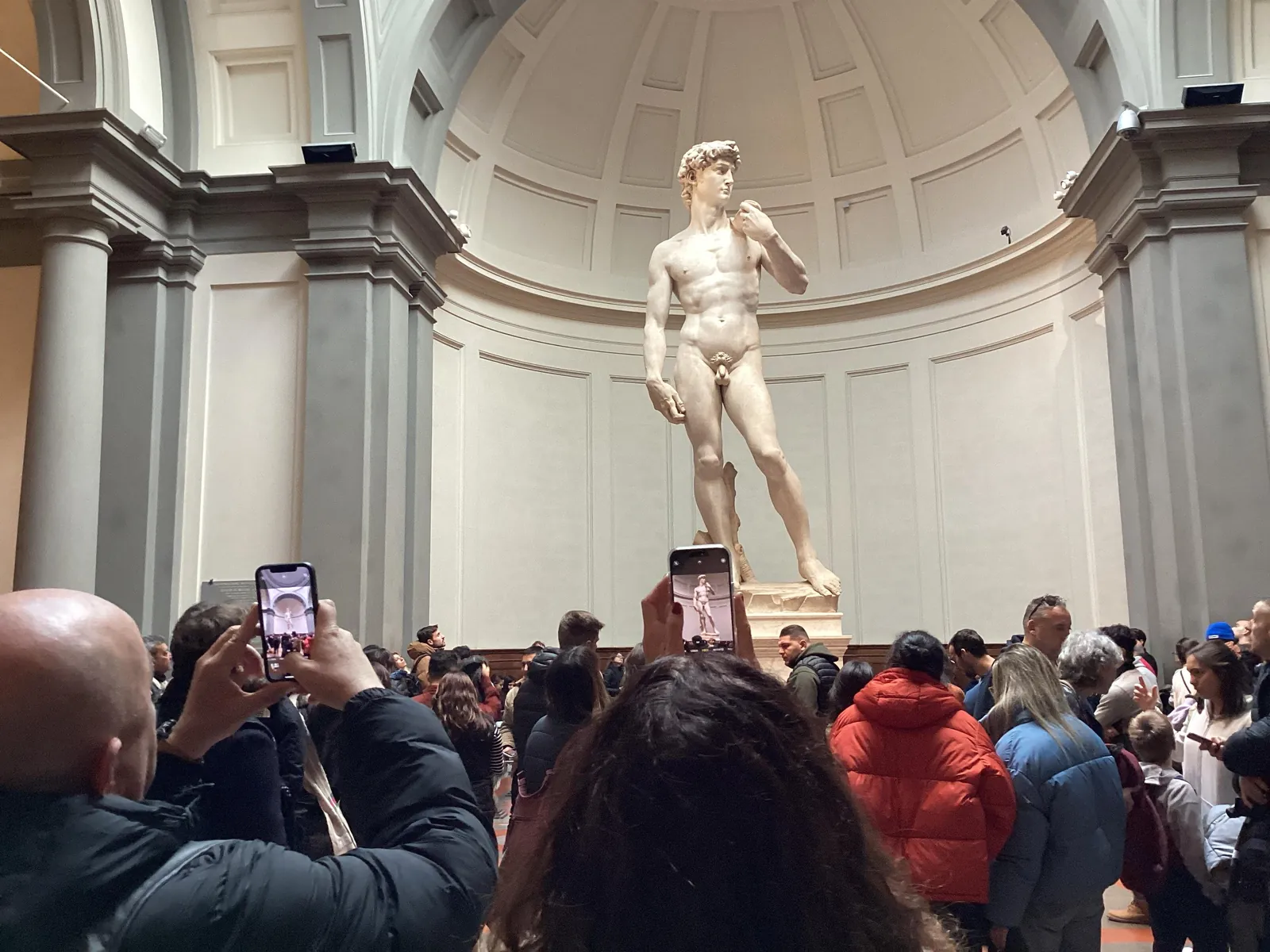 Visitors photographing Michelangelo's David in the Accademia Gallery