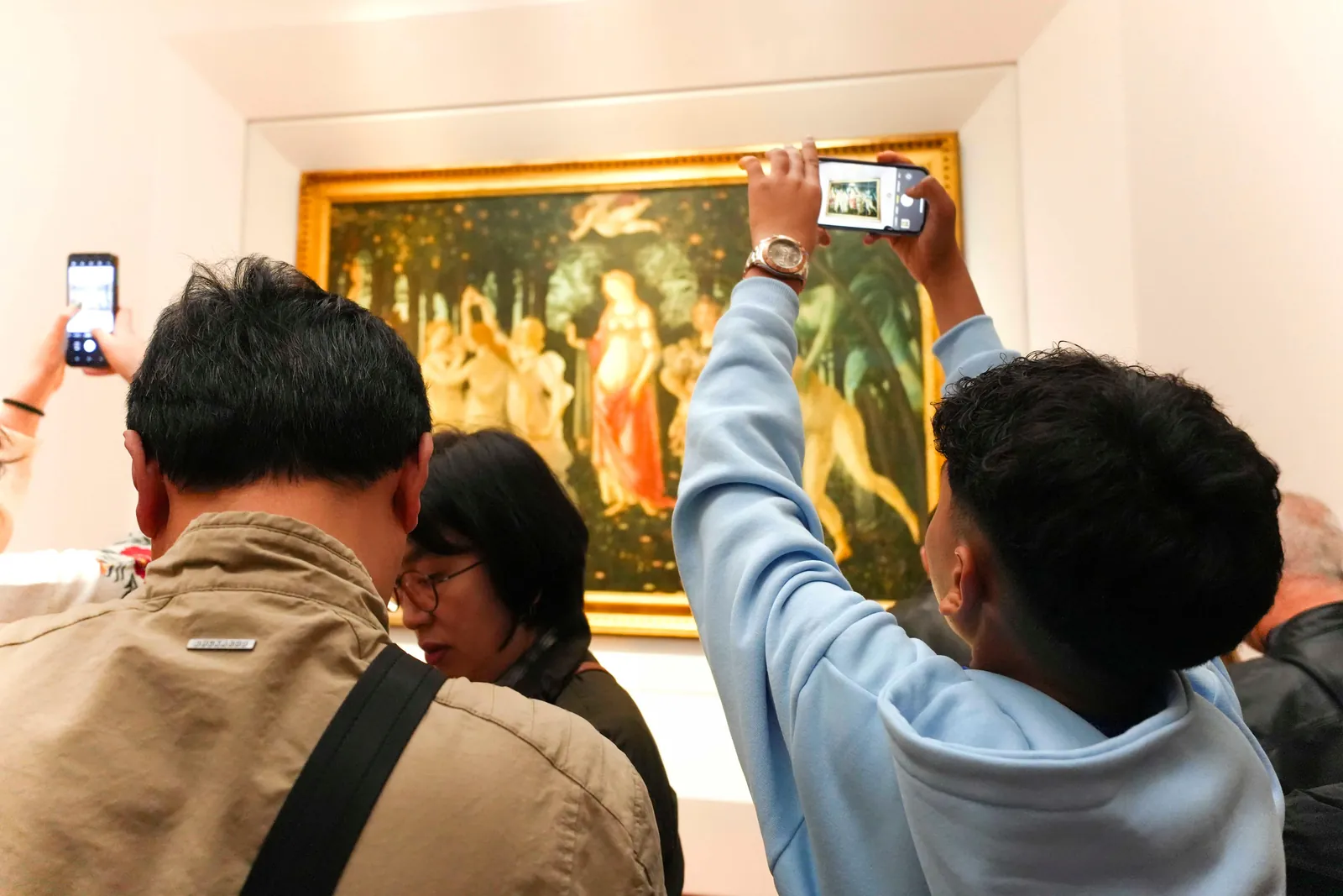 Visitors photographing Botticelli's Primavera in the Uffizi Gallery
