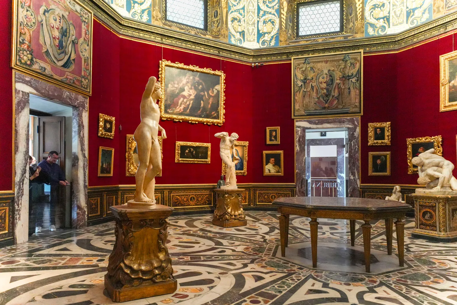 The octagonal Tribuna room with its red walls and inlaid marble floor