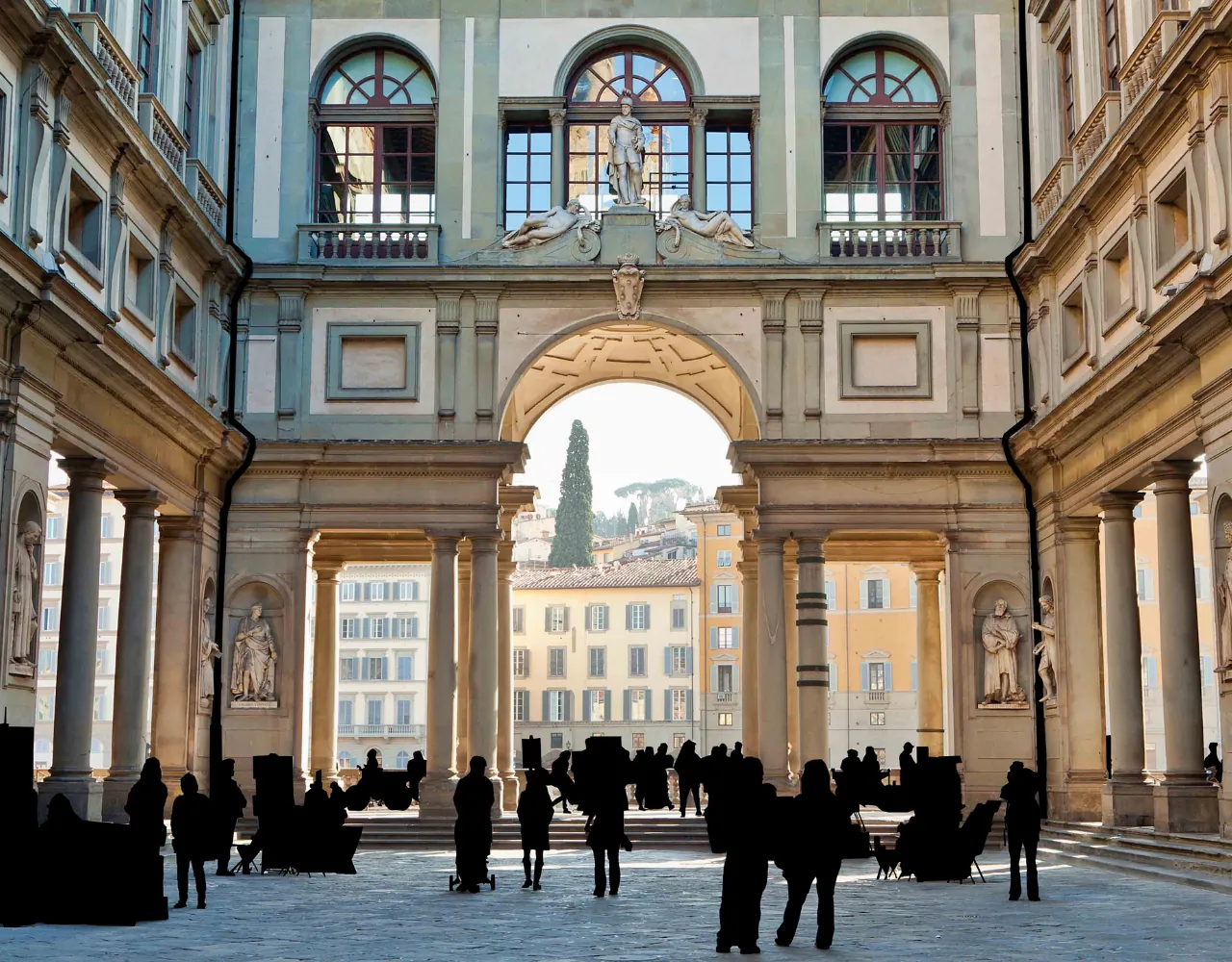 The Uffizi courtyard's river arch with visitors in silhouette