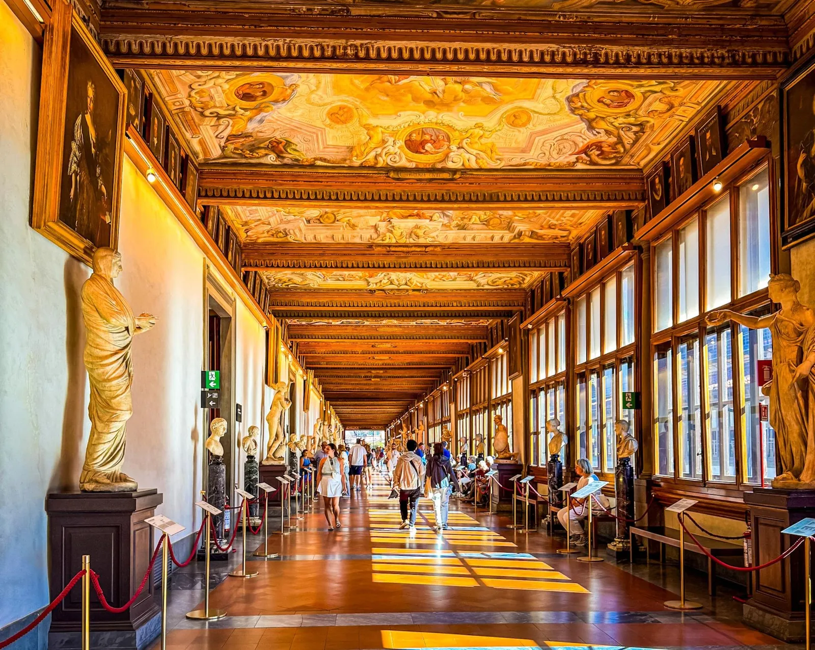 Sunlight across the Uffizi corridor and its grotesque-painted ceiling