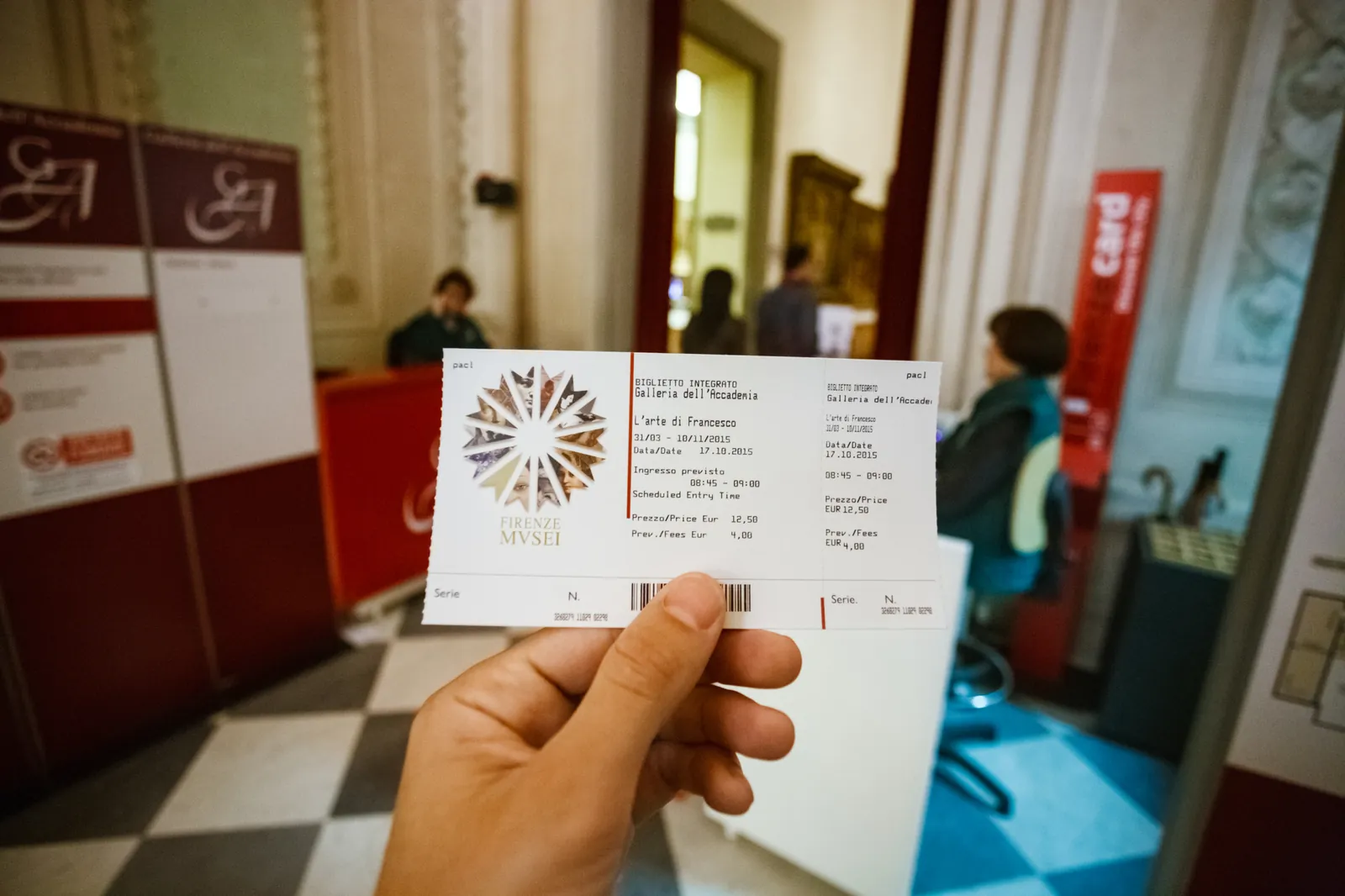 An Accademia Gallery entry ticket held up at the ticket desk
