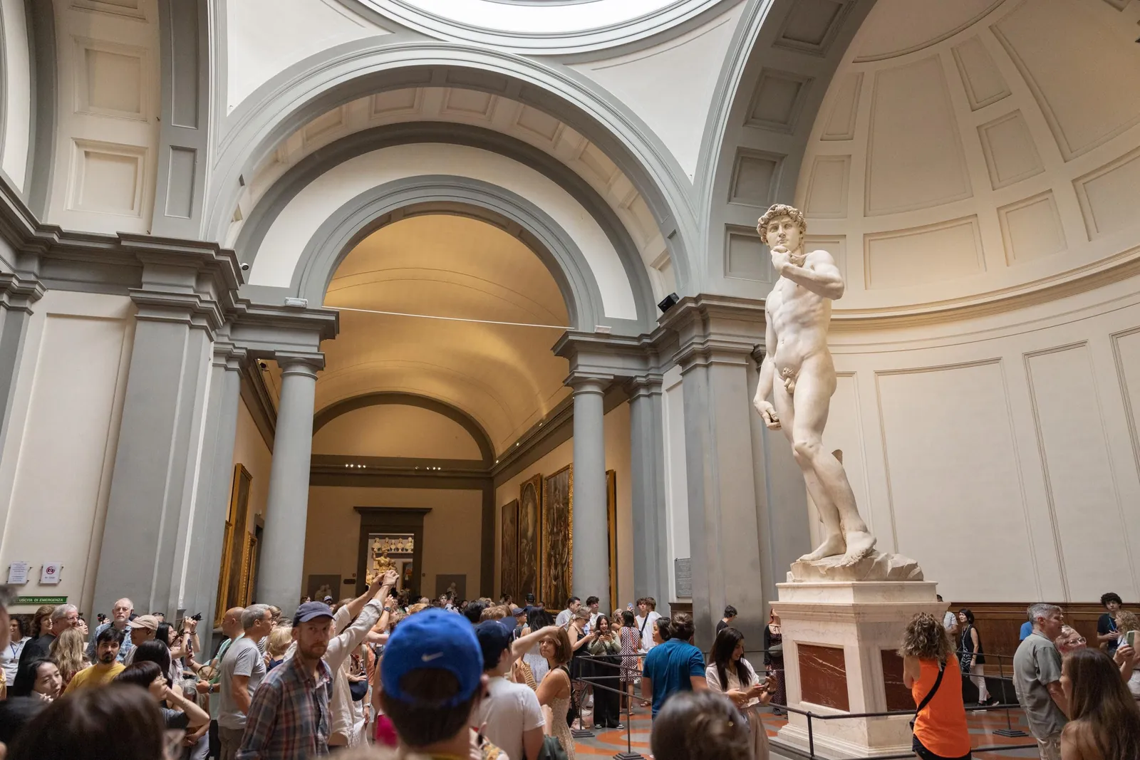 The tribune of the Accademia with visitors circling David