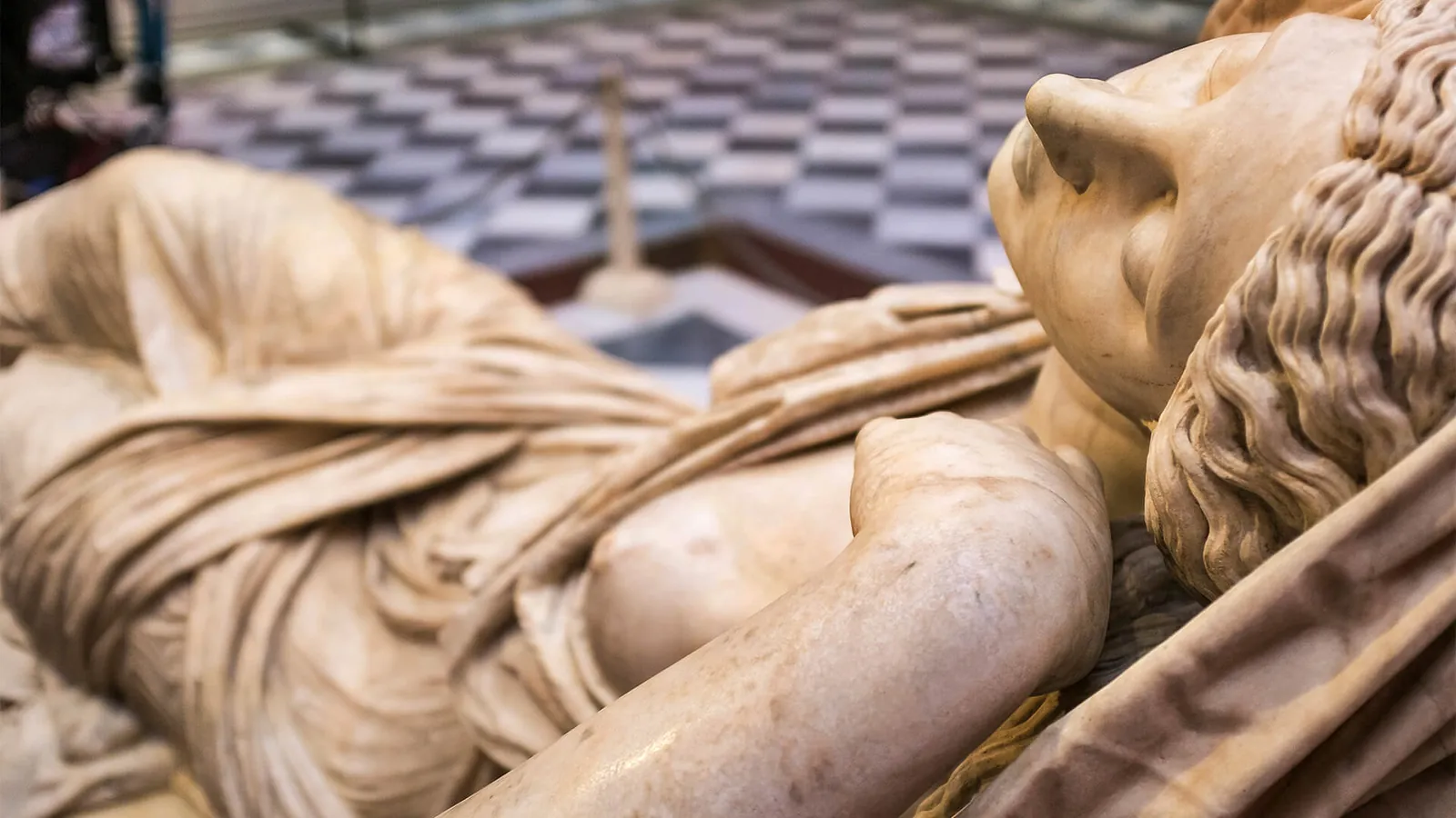 Detail of a reclining marble figure in the Uffizi's sculpture collection