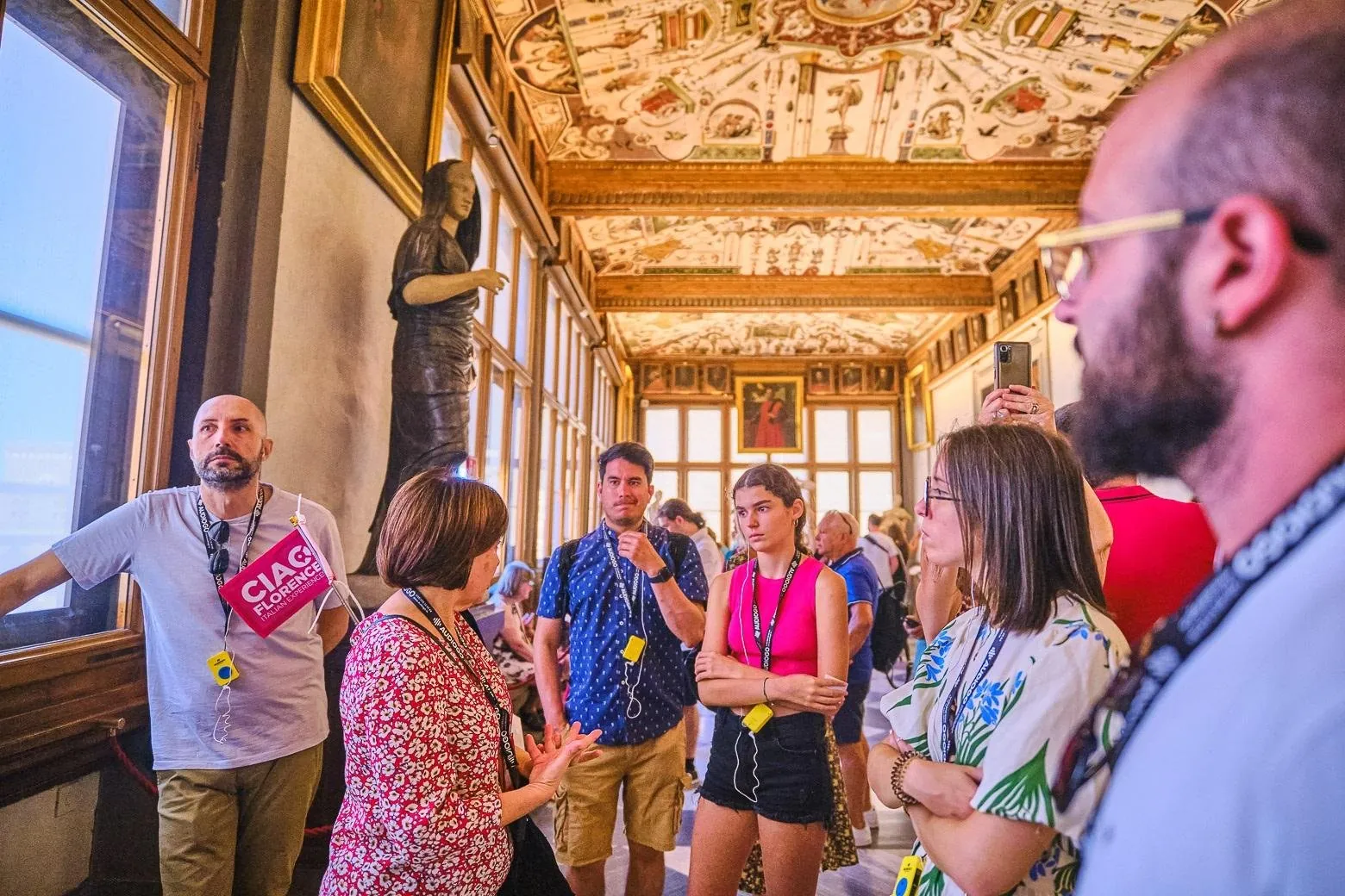 Guide and small group in the Uffizi's frescoed corridor